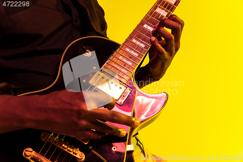 Image of Young african-american jazz musician playing the guitar