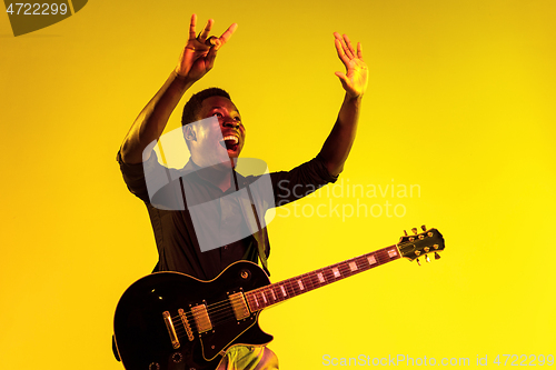 Image of Young african-american jazz musician playing the guitar