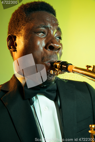 Image of Young african-american jazz musician playing the saxophone