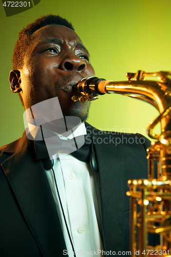 Image of Young african-american jazz musician playing the saxophone