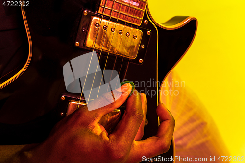 Image of Young african-american jazz musician playing the guitar