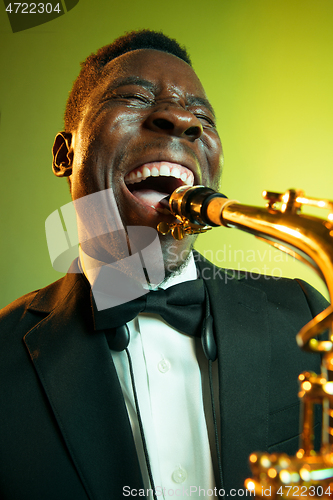 Image of Young african-american jazz musician playing the saxophone