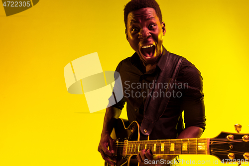 Image of Young african-american jazz musician playing the guitar