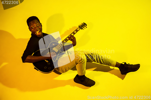 Image of Young african-american jazz musician playing the guitar