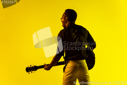 Image of Young african-american jazz musician playing the guitar