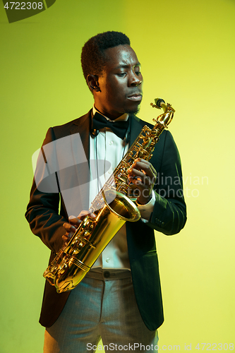 Image of Young african-american jazz musician playing the saxophone