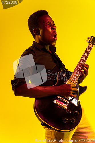 Image of Young african-american jazz musician playing the guitar