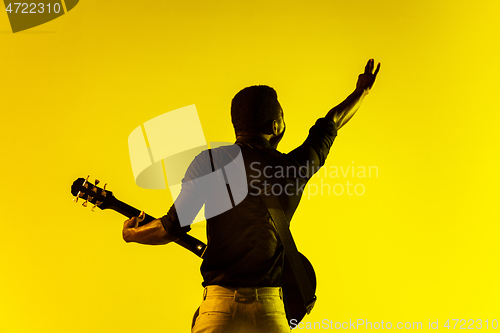 Image of Young african-american jazz musician playing the guitar