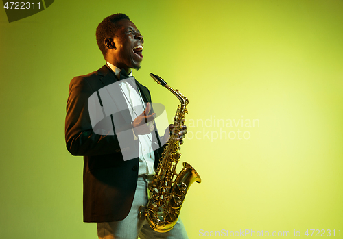 Image of Young african-american jazz musician playing the saxophone