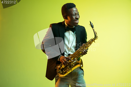 Image of Young african-american jazz musician playing the saxophone