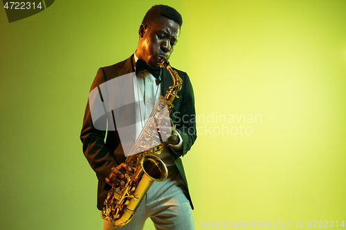 Image of Young african-american jazz musician playing the saxophone