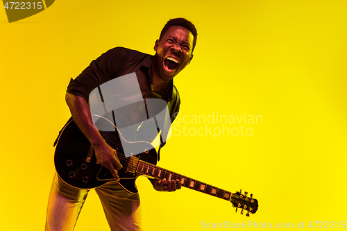 Image of Young african-american jazz musician playing the guitar