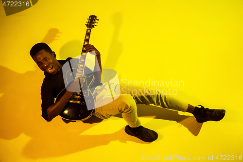 Image of Young african-american jazz musician playing the guitar