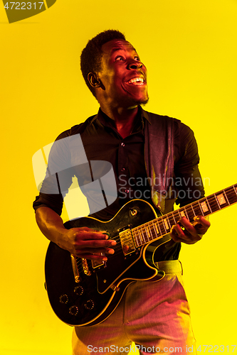 Image of Young african-american jazz musician playing the guitar