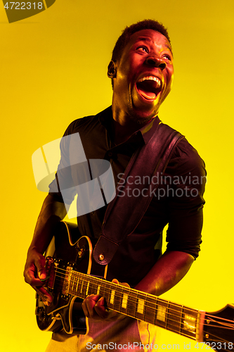 Image of Young african-american jazz musician playing the guitar