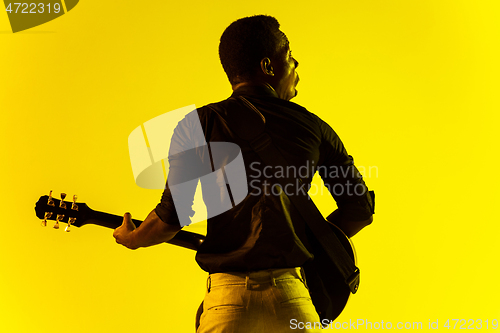 Image of Young african-american jazz musician playing the guitar