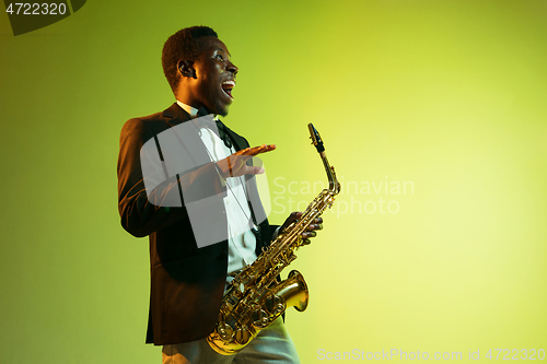 Image of Young african-american jazz musician playing the saxophone