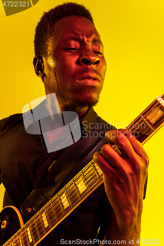 Image of Young african-american jazz musician playing the guitar