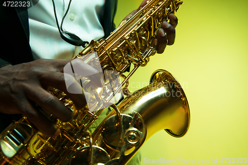 Image of Young african-american jazz musician playing the saxophone