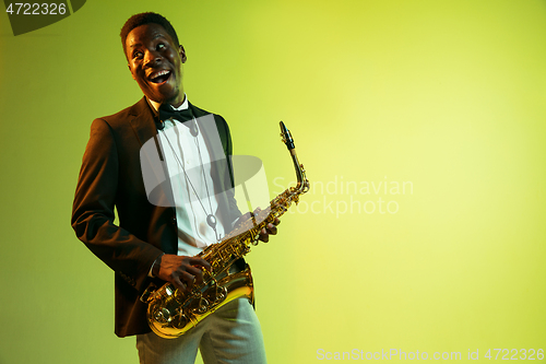 Image of Young african-american jazz musician playing the saxophone