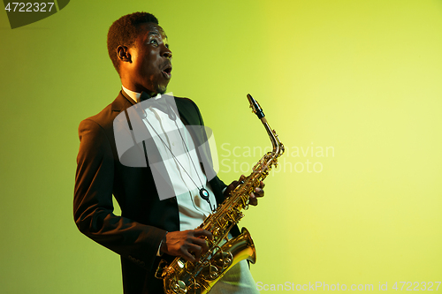 Image of Young african-american jazz musician playing the saxophone