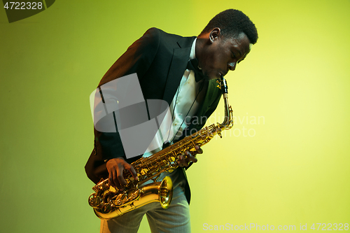 Image of Young african-american jazz musician playing the saxophone