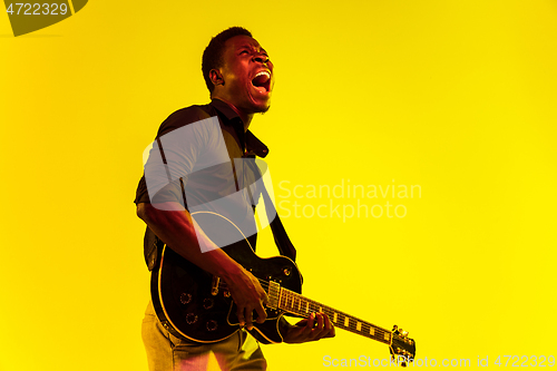 Image of Young african-american jazz musician playing the guitar