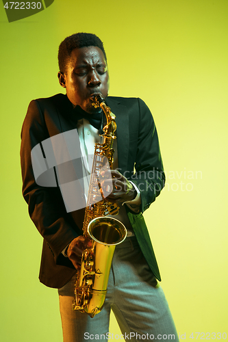 Image of Young african-american jazz musician playing the saxophone