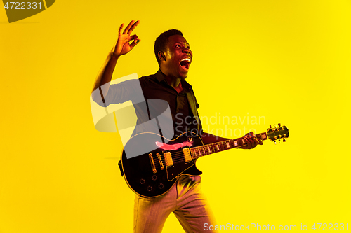 Image of Young african-american jazz musician playing the guitar