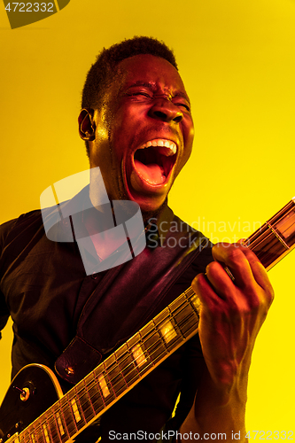 Image of Young african-american jazz musician playing the guitar