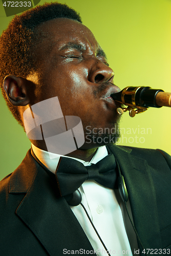 Image of Young african-american jazz musician playing the saxophone