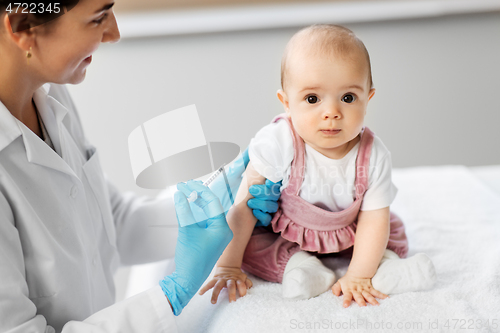 Image of doctor making vaccine for baby patient at clinic