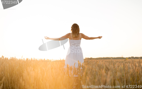 Image of happy woman enjoying freedom on cereal field