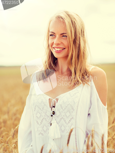 Image of smiling young woman in white dress on cereal field