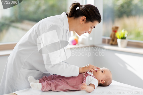 Image of female pediatrician doctor with baby at clinic