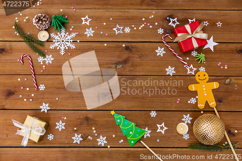 Image of christmas gifts and decorations on wooden boards