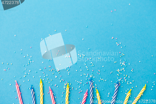 Image of birthday candles with sprinkles on blue background