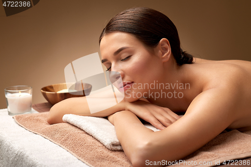 Image of young woman lying at spa or massage parlor