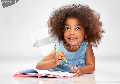 Image of happy little african american girl with sketchbook