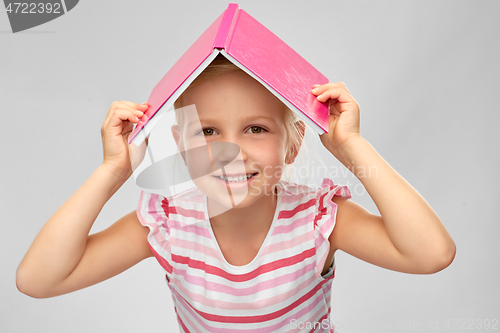 Image of little girl with roof of book on top of her head