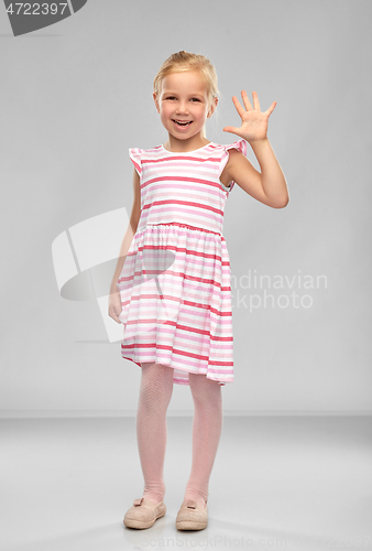 Image of smiling little girl in striped dress