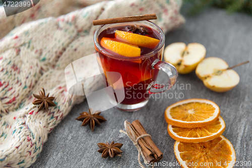 Image of glass of hot mulled wine with orange and cinnamon