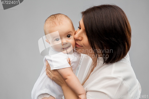 Image of happy mother kissing little baby daughter