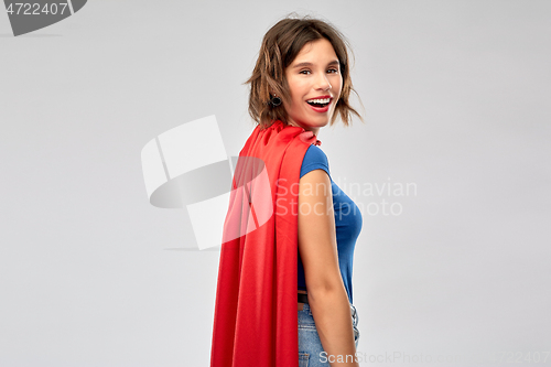 Image of happy woman in red superhero cape