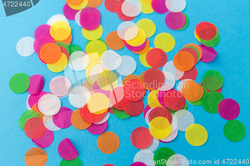 Image of colorful confetti decoration on blue background