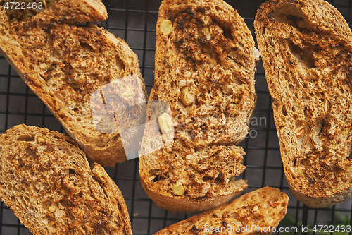 Image of Close up marcor shot of toasted baguette slices placed on grill frame. Top view