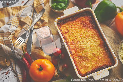 Image of Tasty traditional italian lasagna with bolognese, melted and cheese. Served with ingredients
