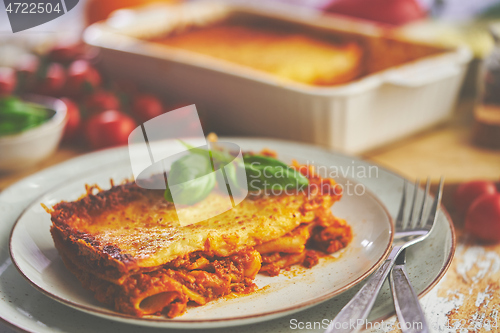 Image of Tasty traditional italian lasagna with bolognese, melted and cheese. Served with ingredients