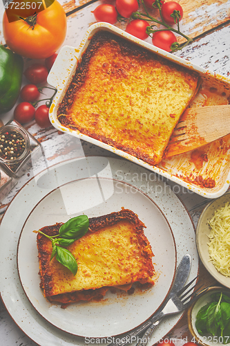 Image of Tasty traditional italian lasagna with bolognese, melted and cheese. Served with ingredients