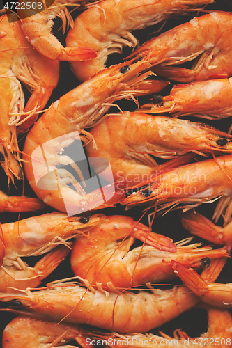 Image of Close up on boiled big sea prawns or shrimps placed on black ceramic plate